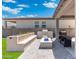 Outdoor kitchen with grill, blue fire pit, patio and lovely landscaped flower bed in backyard at 21134 W Minnezona Ave, Buckeye, AZ 85396