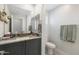 Updated bathroom featuring a modern vanity with quartz countertop, gold faucet and decorative mirror at 21134 W Minnezona Ave, Buckeye, AZ 85396