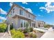 Two-story home featuring manicured landscaping, a spacious driveway, and a modern exterior design at 21134 W Minnezona Ave, Buckeye, AZ 85396