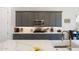 The spacious kitchen features stone countertops, gray cabinetry, a decorative backsplash, and stainless steel appliances at 21134 W Minnezona Ave, Buckeye, AZ 85396