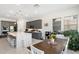 Modern kitchen with stainless steel appliances, pendant lighting, granite countertops, and a center island with seating at 21134 W Minnezona Ave, Buckeye, AZ 85396