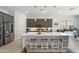 Kitchen features a large island with seating, stainless steel appliances, gray cabinets, and pendant lighting at 21134 W Minnezona Ave, Buckeye, AZ 85396