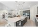 Open floor plan showcasing the kitchen island, stainless steel appliances, and living room area at 21134 W Minnezona Ave, Buckeye, AZ 85396