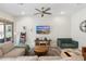 Bright living room features a large sectional sofa, patterned rug, and a flat-screen TV for entertainment at 21134 W Minnezona Ave, Buckeye, AZ 85396