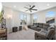 Bright living room with plush seating, large windows, and plenty of space for relaxation and entertainment at 21134 W Minnezona Ave, Buckeye, AZ 85396