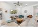 Cozy living room with comfortable seating, a wooden coffee table, and a large wall-mounted television at 21134 W Minnezona Ave, Buckeye, AZ 85396