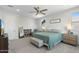 Spacious main bedroom with carpet, ceiling fan, large windows, and comfortable furnishings at 21134 W Minnezona Ave, Buckeye, AZ 85396