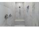 Elegant shower with white marble tile and convenient built-in bench and niche for toiletries at 21134 W Minnezona Ave, Buckeye, AZ 85396