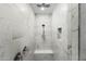 Luxurious marble shower with rainfall head, handheld wand, bench, and built-in niche at 21134 W Minnezona Ave, Buckeye, AZ 85396