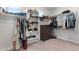 Spacious walk-in closet with built-in shelving and ample storage for clothing and accessories at 21134 W Minnezona Ave, Buckeye, AZ 85396
