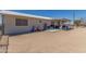Fenced backyard with a white home, covered patio, toys, and chairs at 22578 E Sahara Dr, Florence, AZ 85132