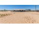 Expansive backyard with desert vegetation, enclosed fencing, and a covered patio at 22578 E Sahara Dr, Florence, AZ 85132