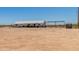 Wide shot of fenced in backyard with home, shed and covered parking at 22578 E Sahara Dr, Florence, AZ 85132