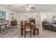 Comfortable dining room includes wooden table with seating for four beneath modern ceiling fan, creating inviting atmosphere at 22578 E Sahara Dr, Florence, AZ 85132