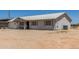Single-story home featuring a metal roof, desert landscaping, and a front porch with chairs at 22578 E Sahara Dr, Florence, AZ 85132