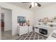A bright home office features built-in shelving and a decorative ceiling fan at 22578 E Sahara Dr, Florence, AZ 85132
