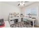 Bright home office with large desk, ceiling fan and a patterned gray rug at 22578 E Sahara Dr, Florence, AZ 85132