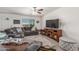 Relaxing living room featuring a comfortable gray sectional, TV, and stylish decor, perfect for movie nights or entertaining at 22578 E Sahara Dr, Florence, AZ 85132