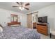 Main bedroom with ceiling fan, dresser, and a barn door to the ensuite bathroom at 22578 E Sahara Dr, Florence, AZ 85132