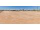 Wide shot of desert property with multiple houses and bare land at 22578 E Sahara Dr, Florence, AZ 85132