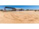 Desert property with a single-story white home, barn, and covered parking at 22578 E Sahara Dr, Florence, AZ 85132