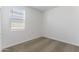 Bright bedroom featuring neutral carpet, white walls, and large bright windows at 22580 N Lynn St, Maricopa, AZ 85138