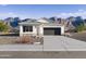 Charming single-story home with a two-car garage, desert landscaping, and mountain views at 22580 N Lynn St, Maricopa, AZ 85138