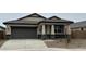 Charming single-story home featuring neutral stucco, a two-car garage, and stone accents for a modern curb appeal at 22580 N Lynn St, Maricopa, AZ 85138