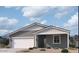 Charming single-story home with a two-car garage, neutral color palette, and nicely landscaped front yard at 24096 W Bowker St, Buckeye, AZ 85326