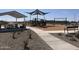 Community playground with slides, swings, and a picnic area, perfect for Gathering activities at 24096 W Bowker St, Buckeye, AZ 85326