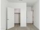 Bedroom with closet featuring neutral carpet, and a doorway to another room at 25478 W Graham Trl, Buckeye, AZ 85326