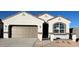 Charming single-Gathering home featuring a two-car garage, stone accents, and manicured landscaping at 25478 W Graham Trl, Buckeye, AZ 85326