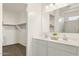 Bright bathroom with double sinks, white cabinets, and a glass-enclosed shower at 25481 W Graham Trl, Buckeye, AZ 85326