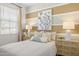 Cozy bedroom with striped accent wall, modern nightstands, soft bedding, and natural light at 25481 W Graham Trl, Buckeye, AZ 85326