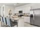 Modern kitchen featuring stainless steel appliances, granite countertops, white cabinetry, and a center island with seating at 25481 W Graham Trl, Buckeye, AZ 85326