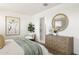 Serene main bedroom with modern decor, a large dresser, and neutral tones for a relaxing atmosphere at 25481 W Graham Trl, Buckeye, AZ 85326