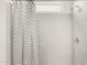 Bright shower with patterned shower curtain and tile at 25481 W Graham Trl, Buckeye, AZ 85326