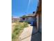 Exterior shot of backyard featuring sparse grass, concrete walkway, and tall fencing at 3308 W Missouri Ave, Phoenix, AZ 85017