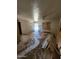 Living room featuring tile floors, boarded window, and construction materials at 3308 W Missouri Ave, Phoenix, AZ 85017