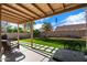 Inviting backyard featuring a covered patio, lush artificial grass, and a well-manicured landscape at 3350 E Rosemonte Dr, Phoenix, AZ 85050