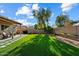 Wide backyard view with artificial grass, patio, and desert landscaping at 3350 E Rosemonte Dr, Phoenix, AZ 85050