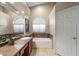 Bathroom featuring a tub, and a vanity with granite countertops, and a decorative backsplash at 3350 E Rosemonte Dr, Phoenix, AZ 85050