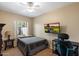 Bright bedroom features a ceiling fan, a large window, and room for work or play at 3350 E Rosemonte Dr, Phoenix, AZ 85050
