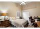 Comfortable bedroom with a ceiling fan, closet, and a dedicated workspace at 3350 E Rosemonte Dr, Phoenix, AZ 85050
