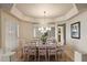 Elegant dining room with a glass top table, seating for eight, and modern lighting at 3350 E Rosemonte Dr, Phoenix, AZ 85050