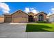 Charming single-story home with a well-manicured lawn and a three-car garage at 3350 E Rosemonte Dr, Phoenix, AZ 85050