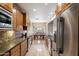 Well-lit kitchen boasts stainless steel appliances and opens to an airy dining area with backyard views at 3350 E Rosemonte Dr, Phoenix, AZ 85050
