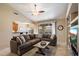 Open-concept living room with a cozy sectional sofa and views of the backyard at 3350 E Rosemonte Dr, Phoenix, AZ 85050