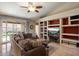 Spacious living room with a large sectional sofa and built-in shelving at 3350 E Rosemonte Dr, Phoenix, AZ 85050