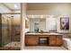 Well-appointed bathroom with a double vanity, step-in shower, and neutral finishes at 3350 E Rosemonte Dr, Phoenix, AZ 85050